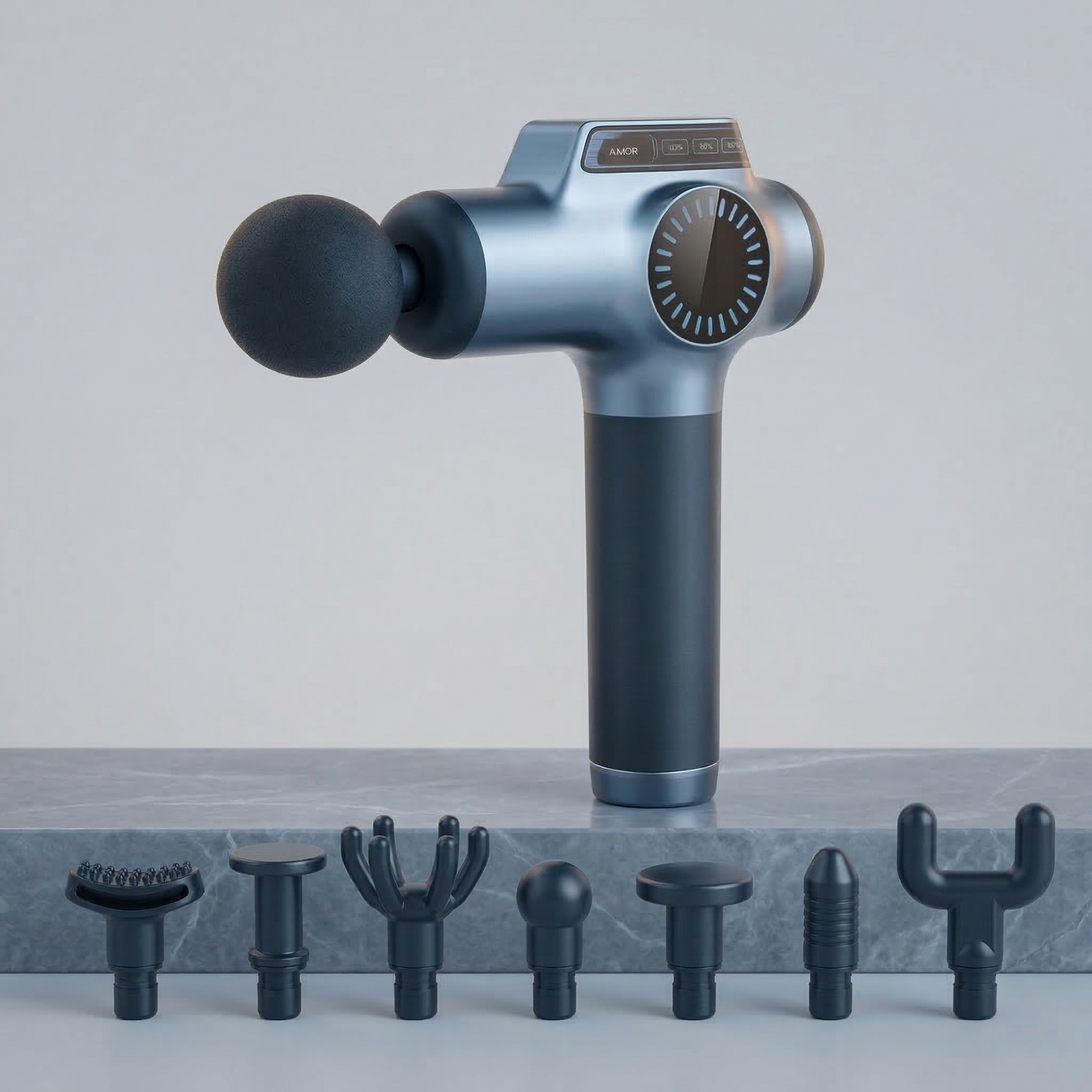 Massage gun with attachments on a gray surface