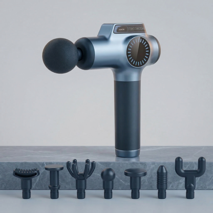 Massage gun with attachments on a gray surface